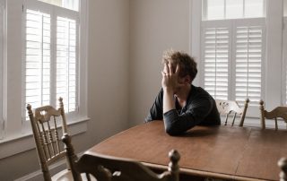 a man alone in a room to illustrate loneliness