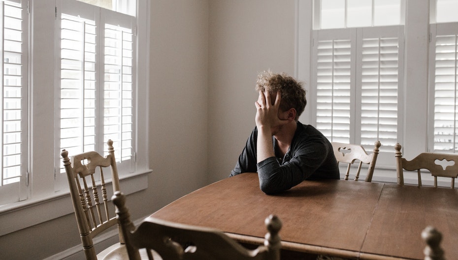 a man alone in a room to illustrate loneliness