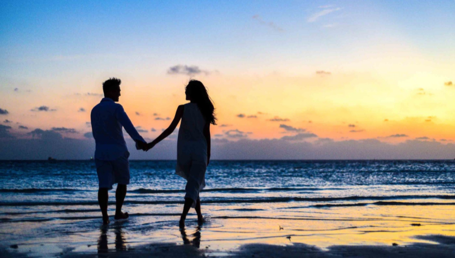 couple holding hands at the beach to illustrate Vows for Eternity Matchmaking