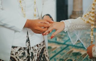 Man putting ring on a woman's finger to illustrate annual matchmaking event