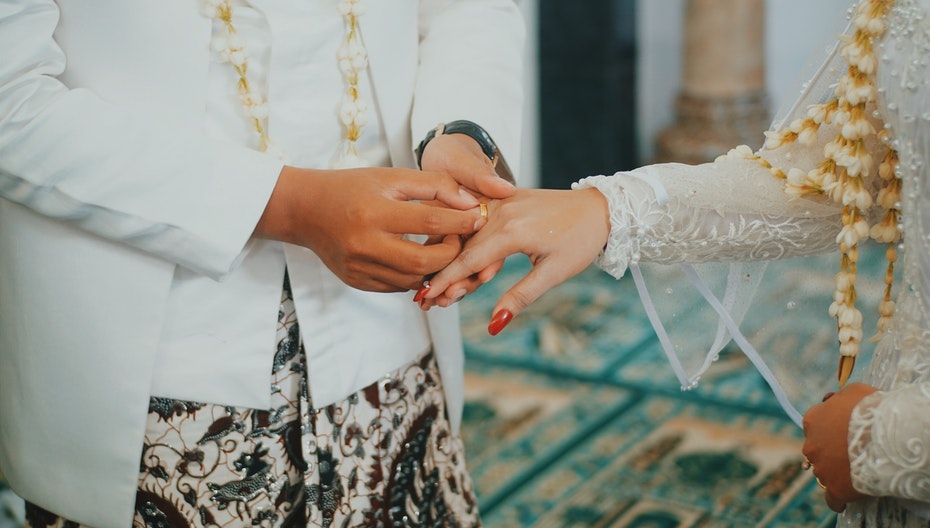 Man putting ring on a woman's finger to illustrate annual matchmaking event