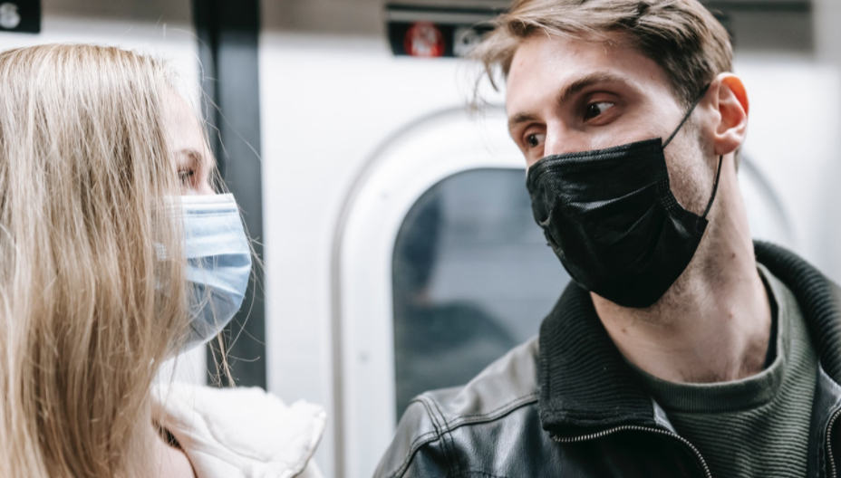 couples on the subway wearing face masks to illustrate pandemic relationships
