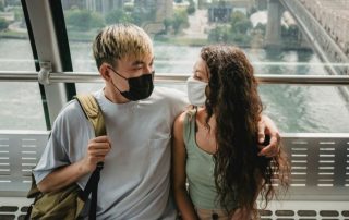 couple with face masks to illustrate hesitant to date