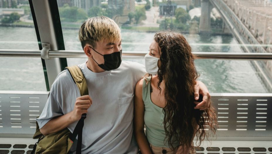 couple with face masks to illustrate hesitant to date
