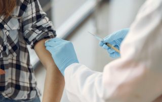 health worker about to vaccinate a woman to illustrate vaccine centers