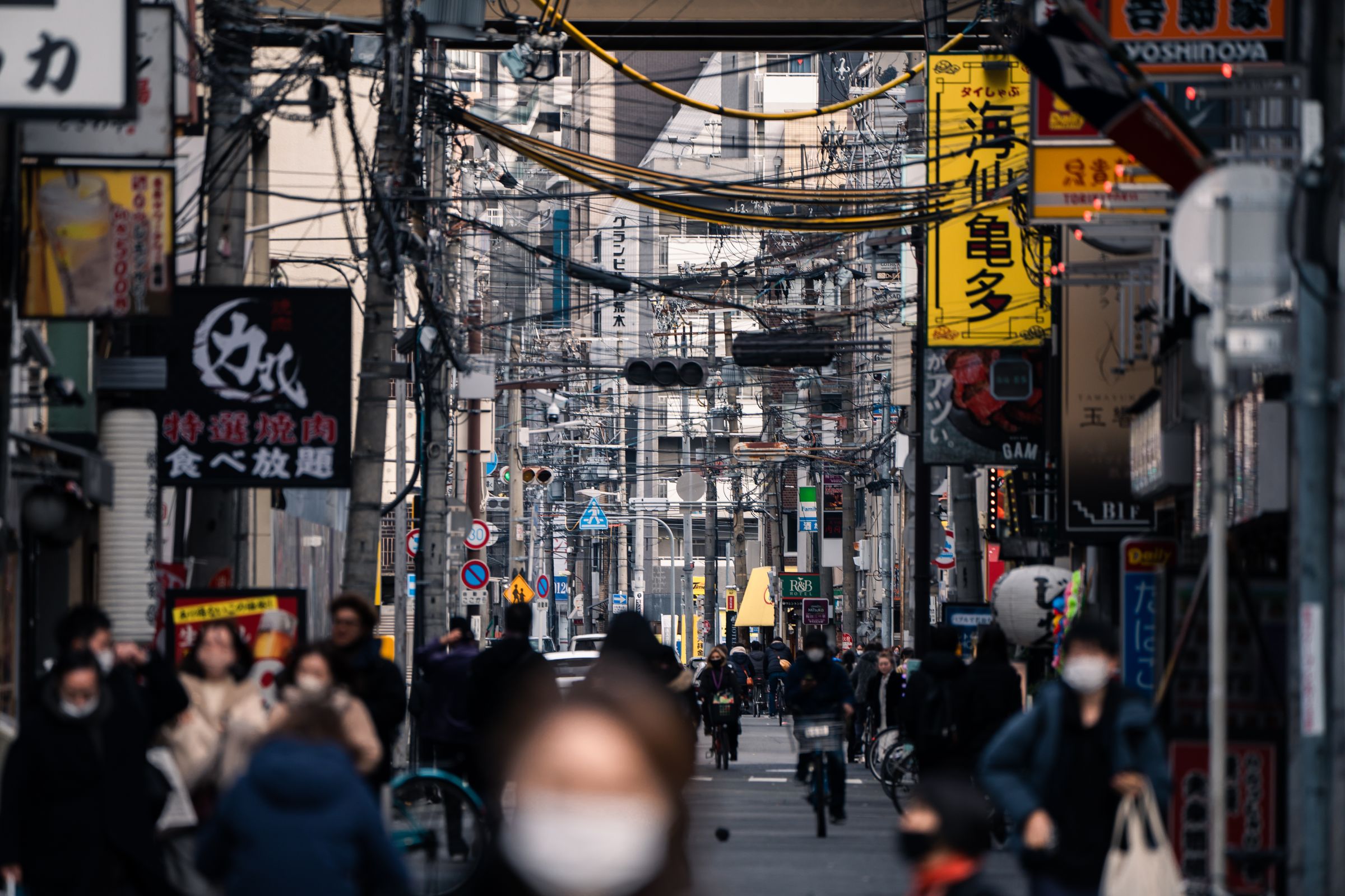 Masked pedestrians on a crowded street in Osaka, Japan