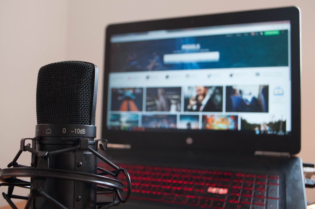 Microphone and laptop set up on a desk for recording a video interview