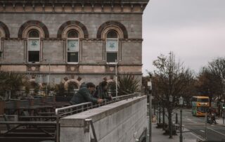 Street view overlooking a historic building and city life in Dublin, Ireland.