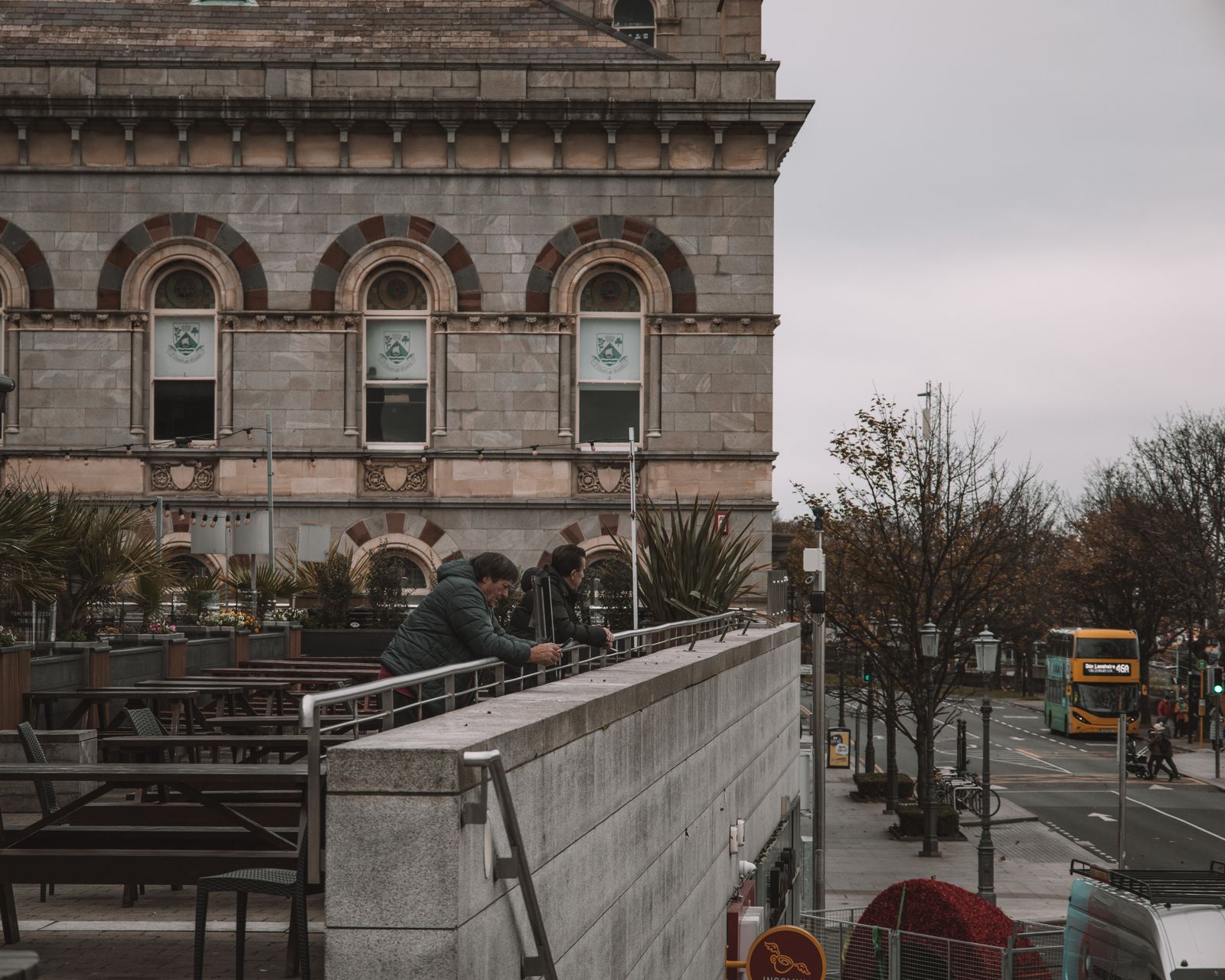 Street view overlooking a historic building and city life in Dublin, Ireland.