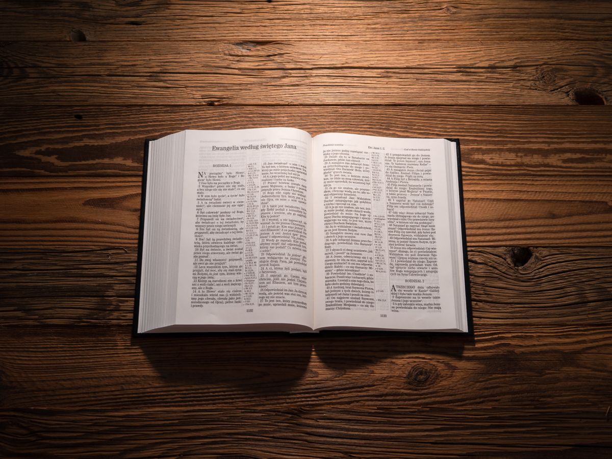 Open Bible on a wooden table in warm light
