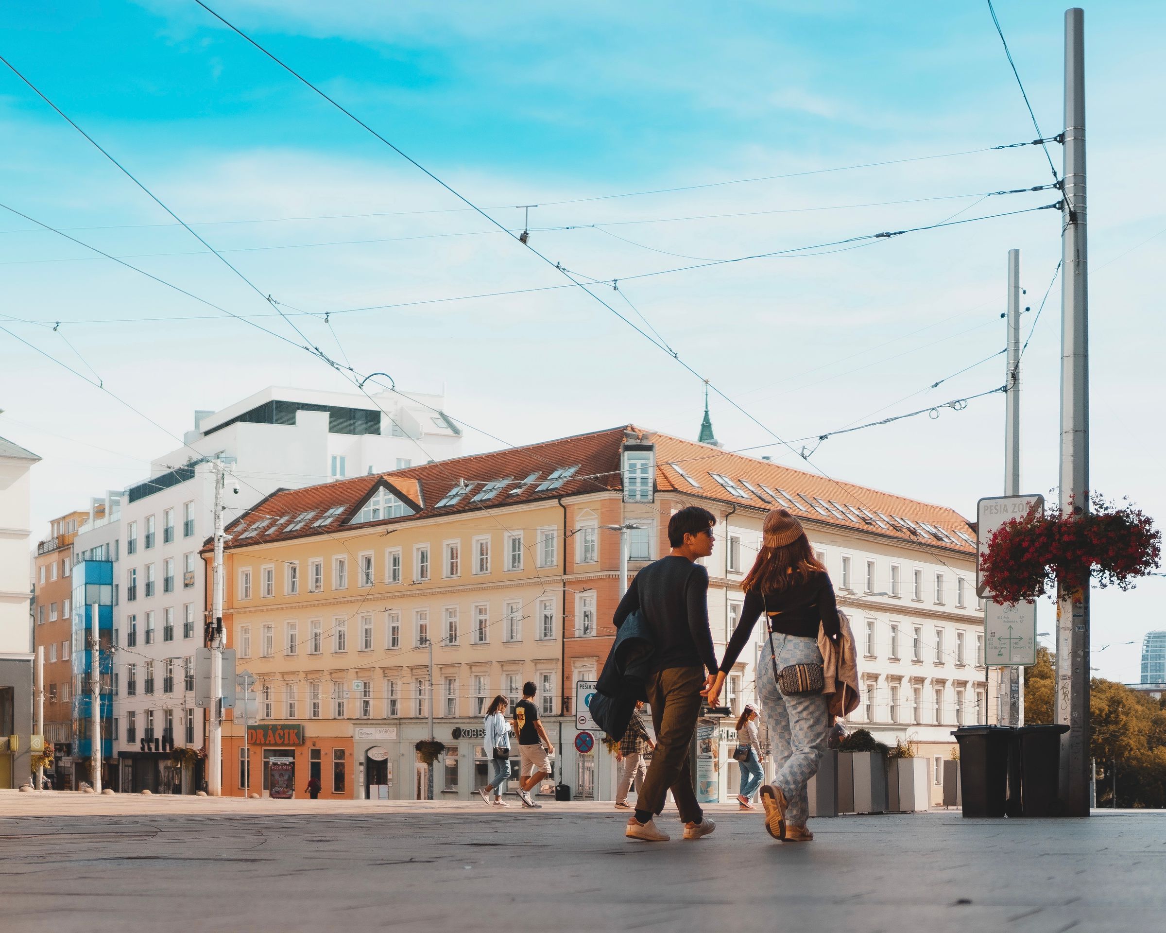 Couple holding hands in a European city street
