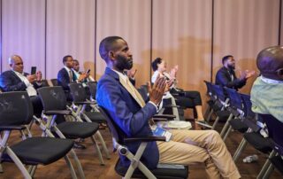 Diverse group clapping during a business conference with focus on engaged participation.