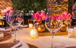 A beautifully decorated table with candles and roses, perfect for a romantic dinner or special event.