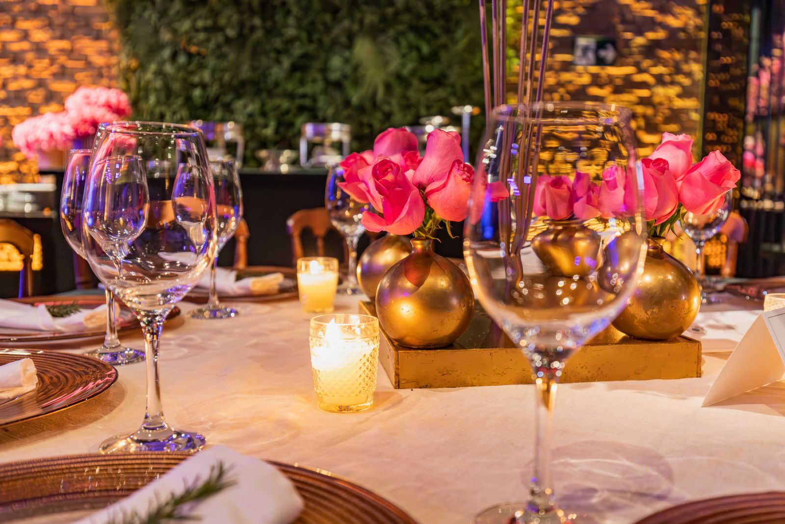 A beautifully decorated table with candles and roses, perfect for a romantic dinner or special event.