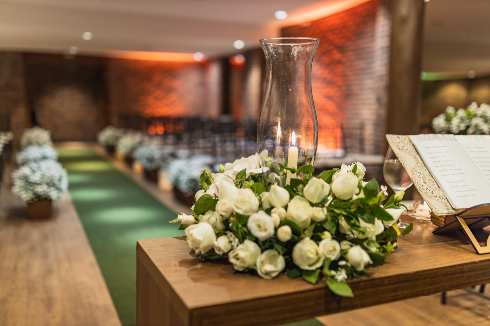 A close-up of a beautiful white rose arrangement at an indoor wedding venue.
