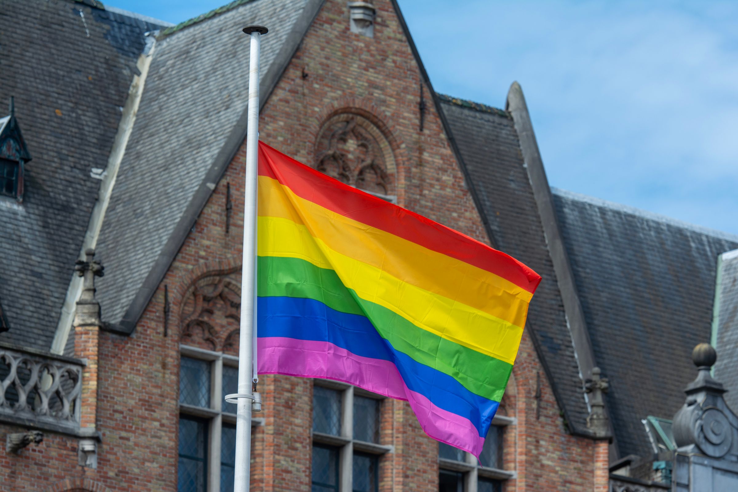 Rainbow pride flag against a historic building facade