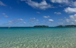 Crystal clear waters at Blue Bay, Grand Port District, Mauritius under a vibrant blue sky.