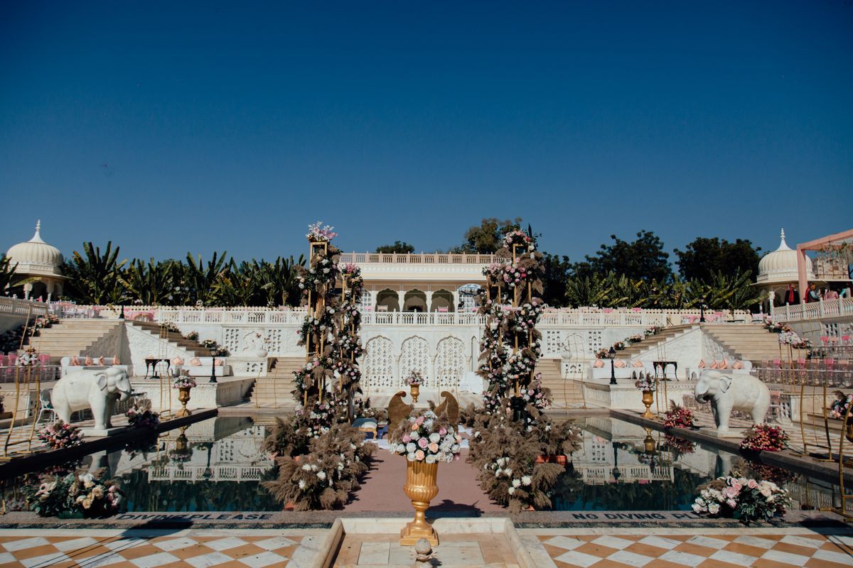 Outdoor Indian wedding venue decorated with floral arrangements