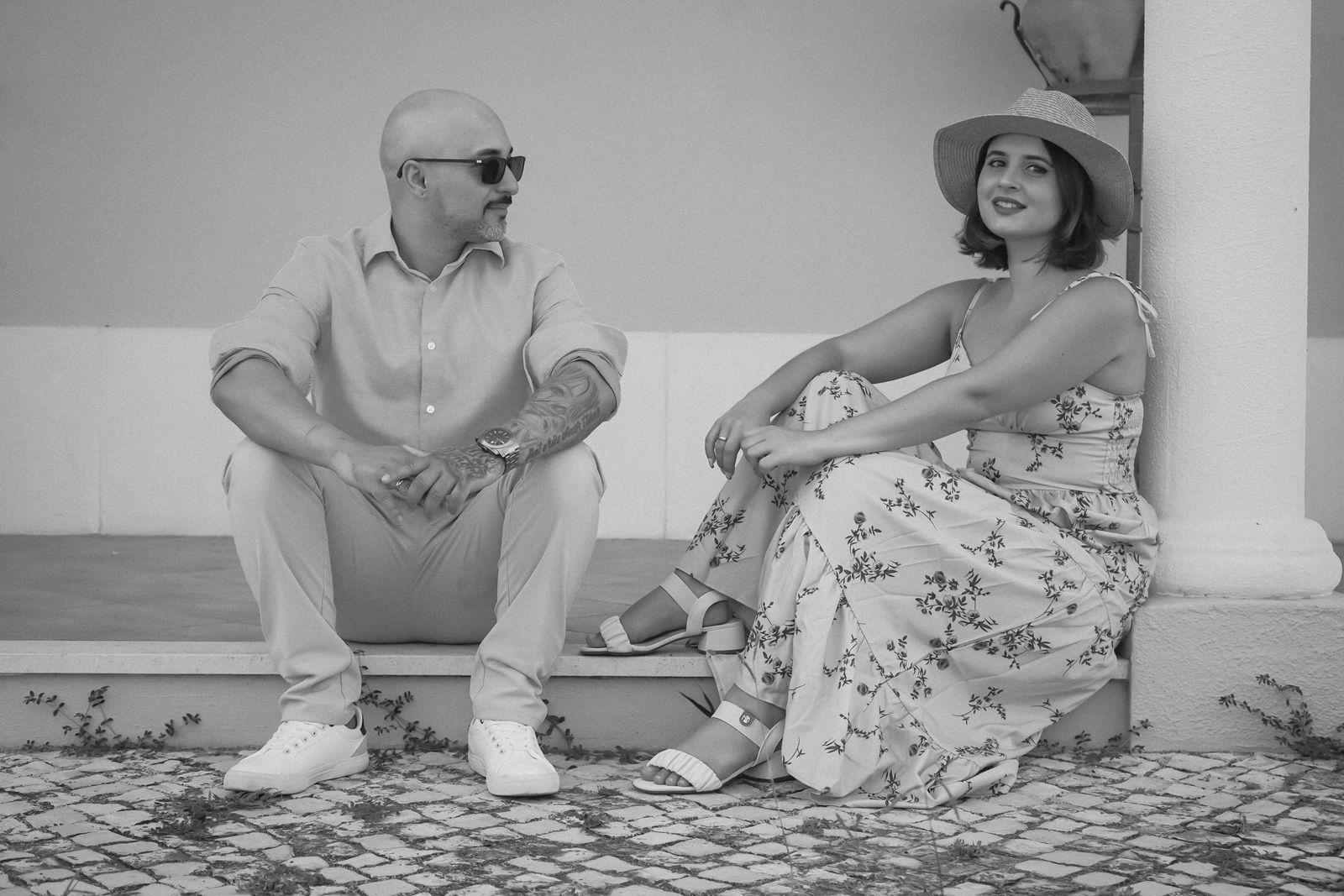 Charming black and white portrait of a couple relaxing outdoors in Palmela, Portugal.
