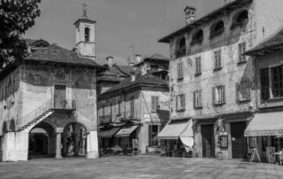 Vintage Italian piazza with historic buildings in a timeless black-and-white composition.