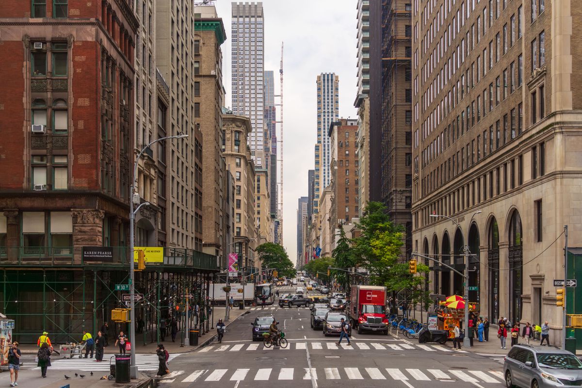 Busy Midtown Manhattan street with pedestrians and traffic