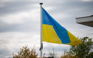 A vibrant Ukrainian flag waving against a cloudy sky, showcasing national pride.