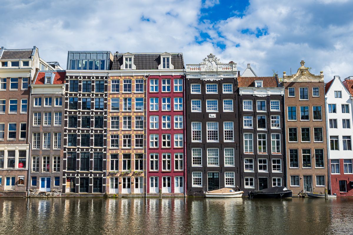 Traditional Amsterdam canal houses reflected in the water