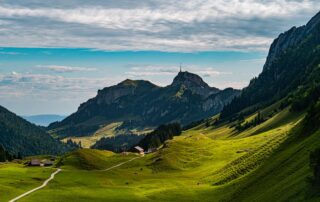 Breathtaking view of lush green valleys and mountains in Sennwald, Switzerland.