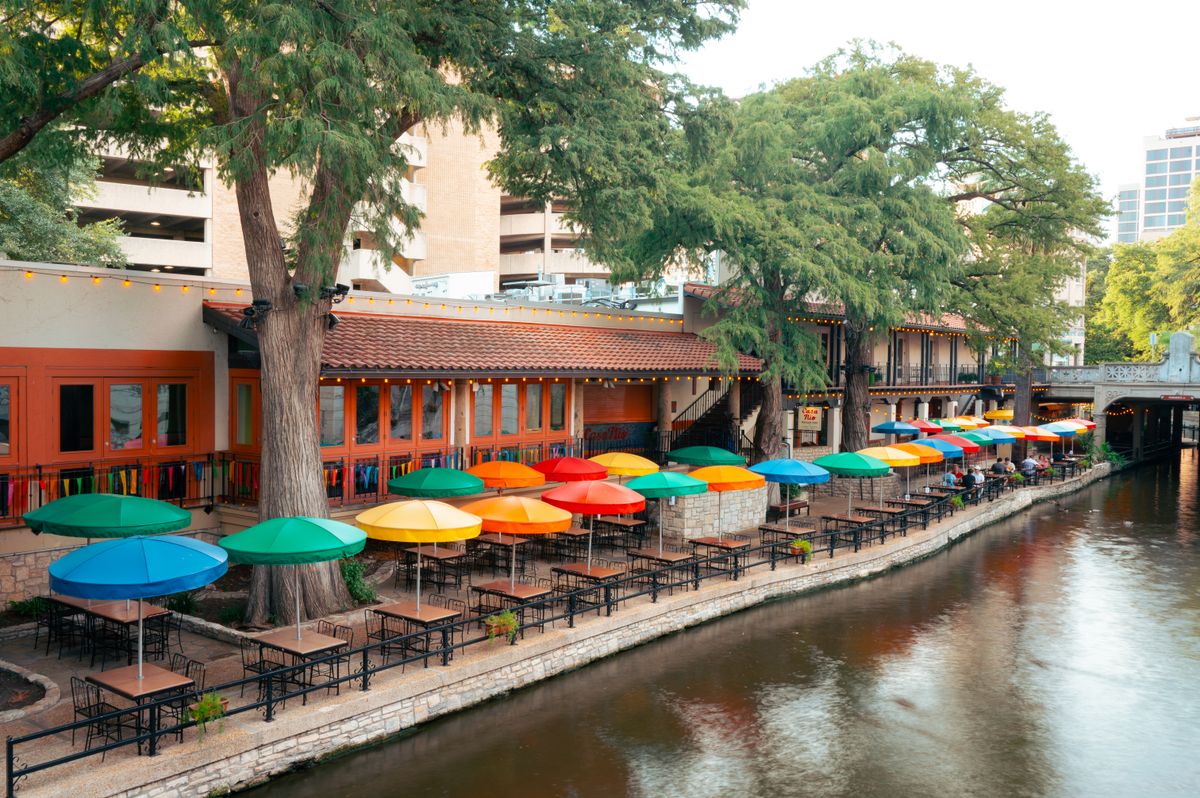 Colorful umbrellas over outdoor dining on the San Antonio River Walk