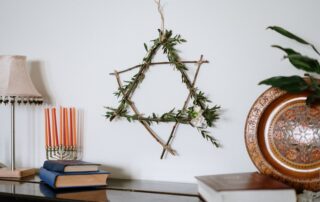 A decorative Star of David with a menorah and books demonstrates Jewish culture in a cozy setting.