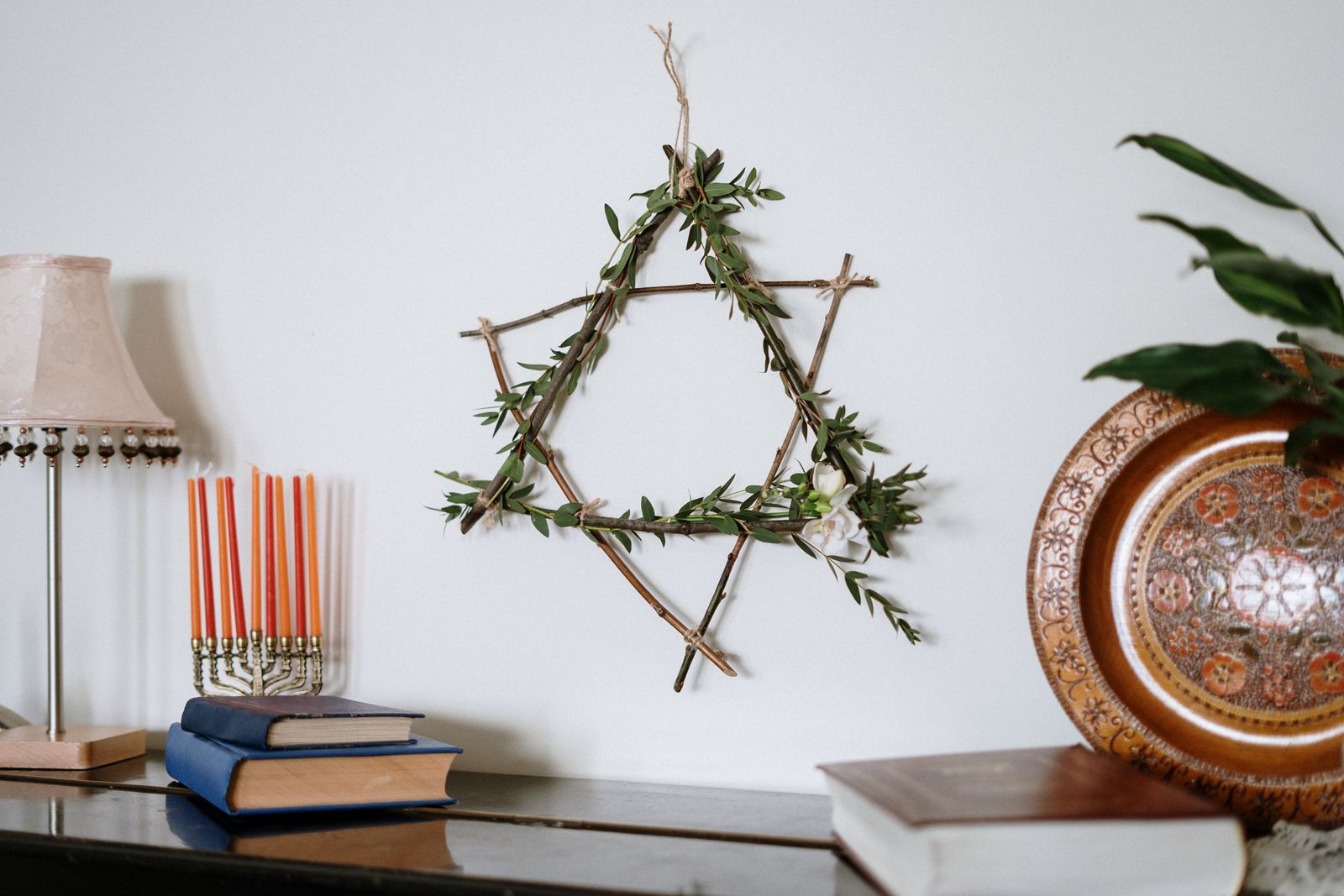 A decorative Star of David with a menorah and books demonstrates Jewish culture in a cozy setting.