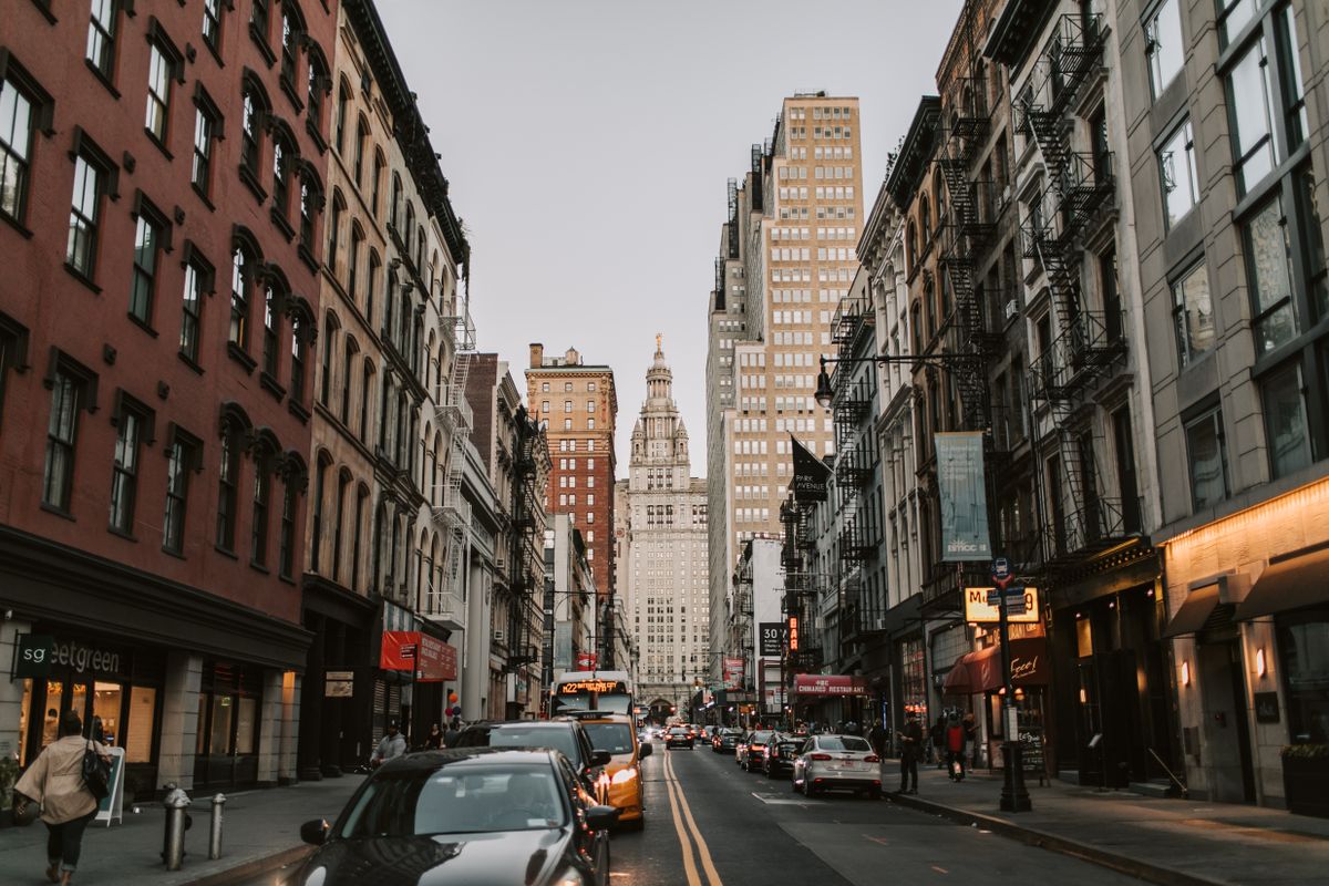 New York City street with historic facades leading toward tall skyscrapers