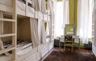Comfortable hostel dorm room with clean bunk beds and a cozy ambiance.