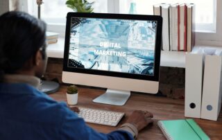 A person working on digital marketing at a well-organized workspace with a computer.