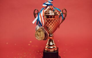 Golden trophy with medals on a red backdrop