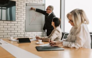 A group of professionals engaging in a business presentation in a stylish office setting.