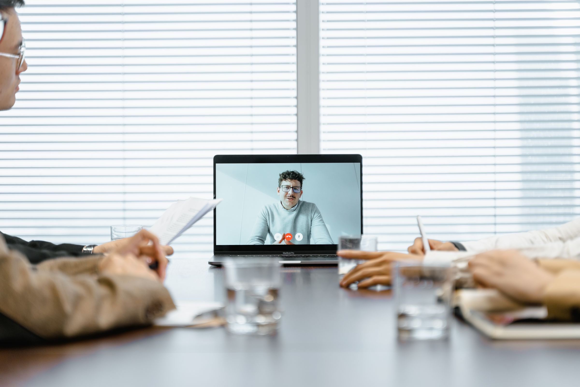 Group of people taking part in an online video meeting on screen