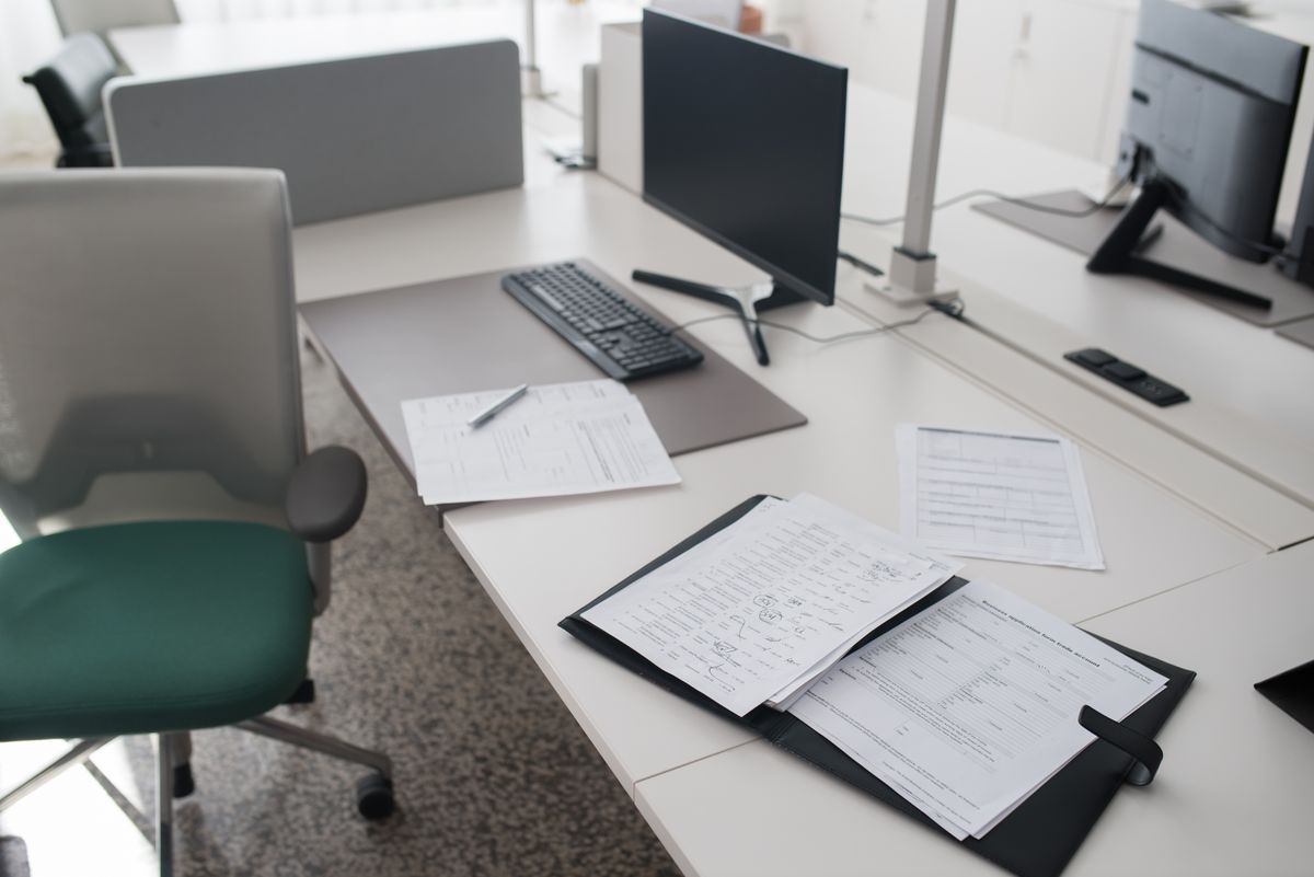 Tidy office desk with documents and a computer