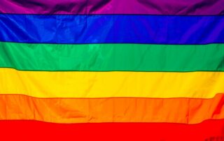 Bright rainbow flag featuring vivid colors representing LGBT pride and diversity.
