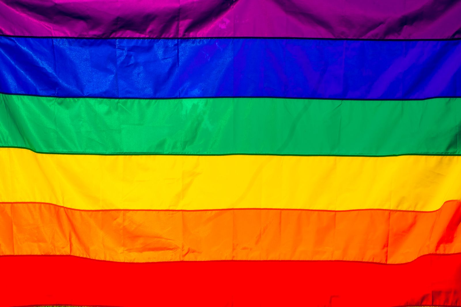 Bright rainbow flag featuring vivid colors representing LGBT pride and diversity.