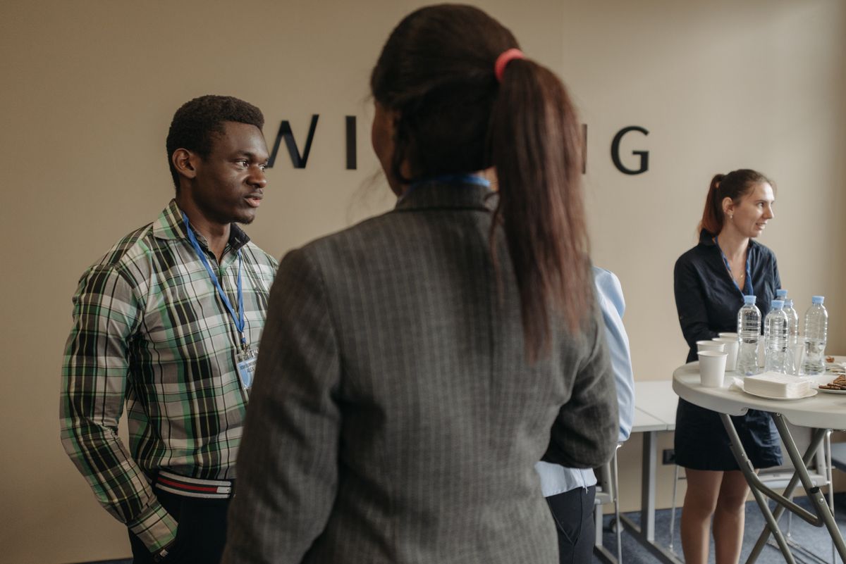 Diverse group of professionals networking at an indoor business seminar